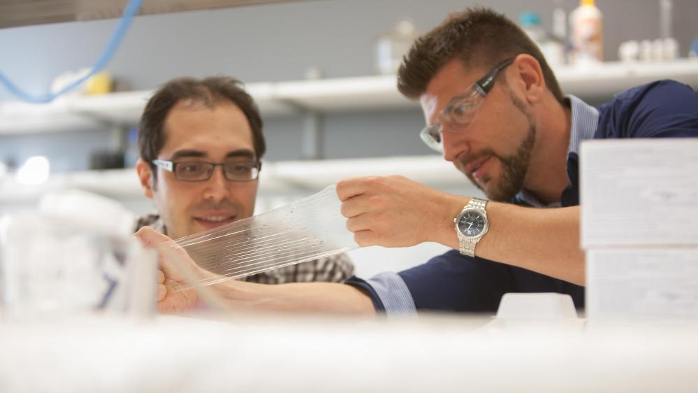 Two researchers with the prototype for the next generation condom